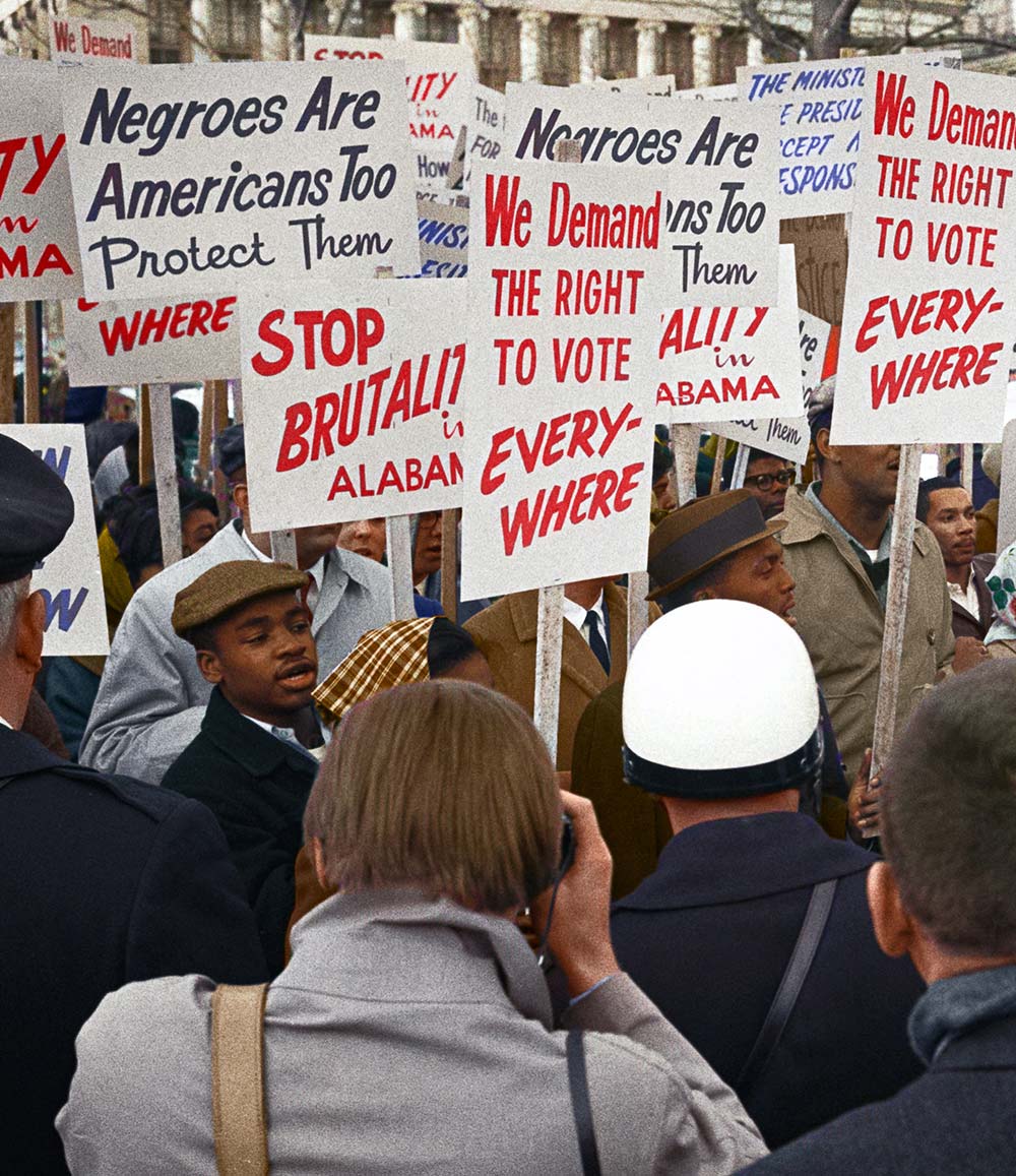A group of people protesting and holding signs