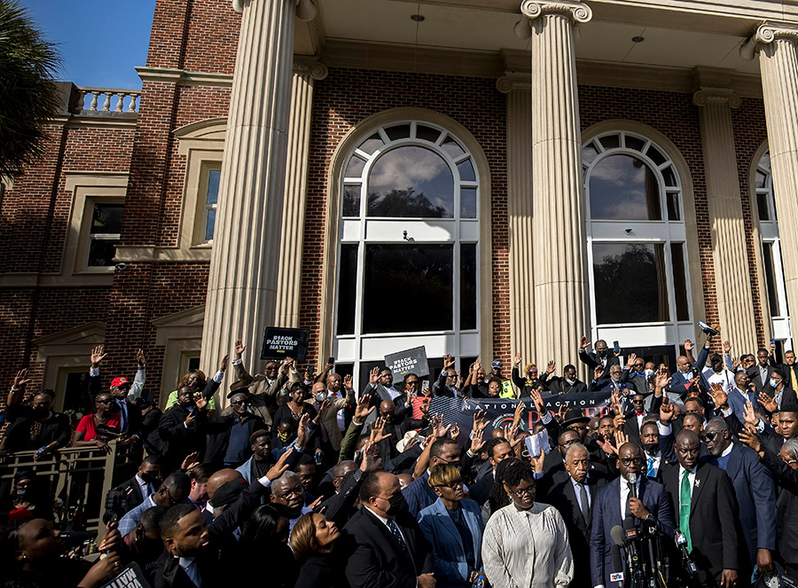 Pastor Jamal Bryant leading a group prayer for to nearly 750 pastors, supporters and family of Ahmaud Arbery gathered outside the Glynn County Courthouse