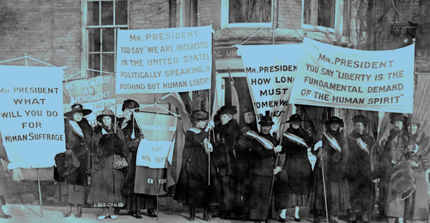 photo of women holding up signs for sufferage