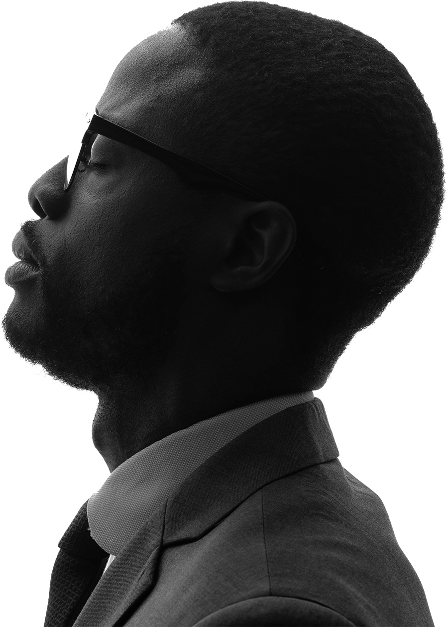 side profile of man wearing prescription glasses and a business suit