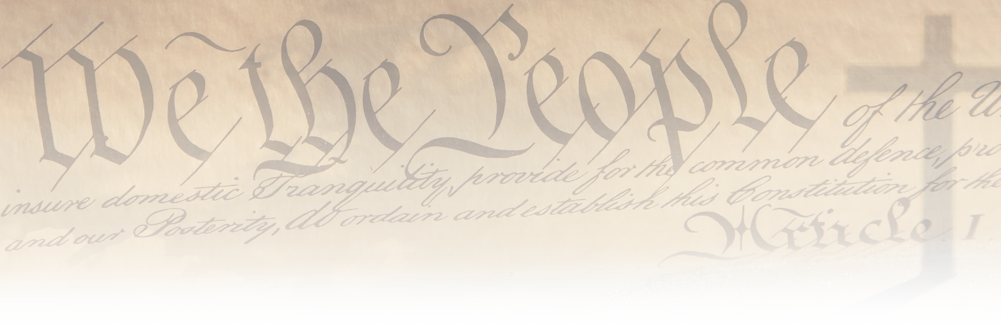 We the People at the top of the Declaration of Independence next to a cross