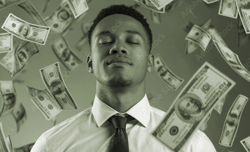 a man holds his head up, his eye closed in serenity as one hundred dollar bills float around him