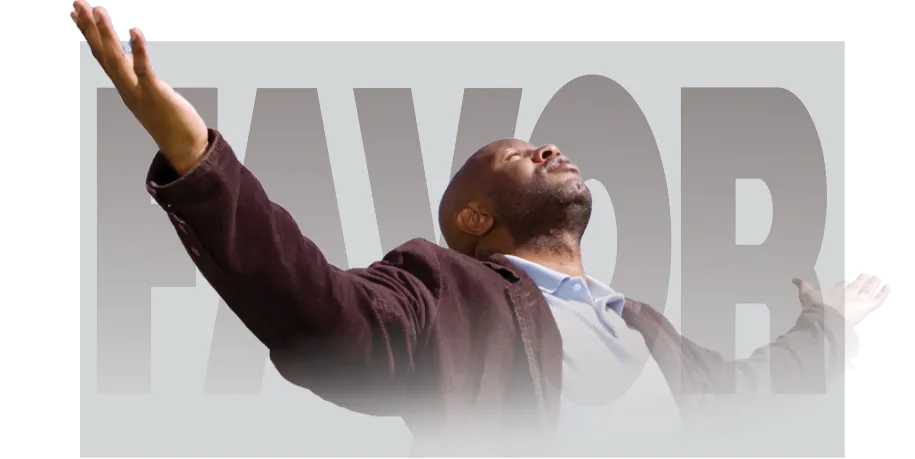 A man with his head tilted upward and arms outstretched in a gesture of praise or surrender. He is wearing a dark blazer and standing in front of a background with the large, semi-transparent word “FAVOR” behind him.