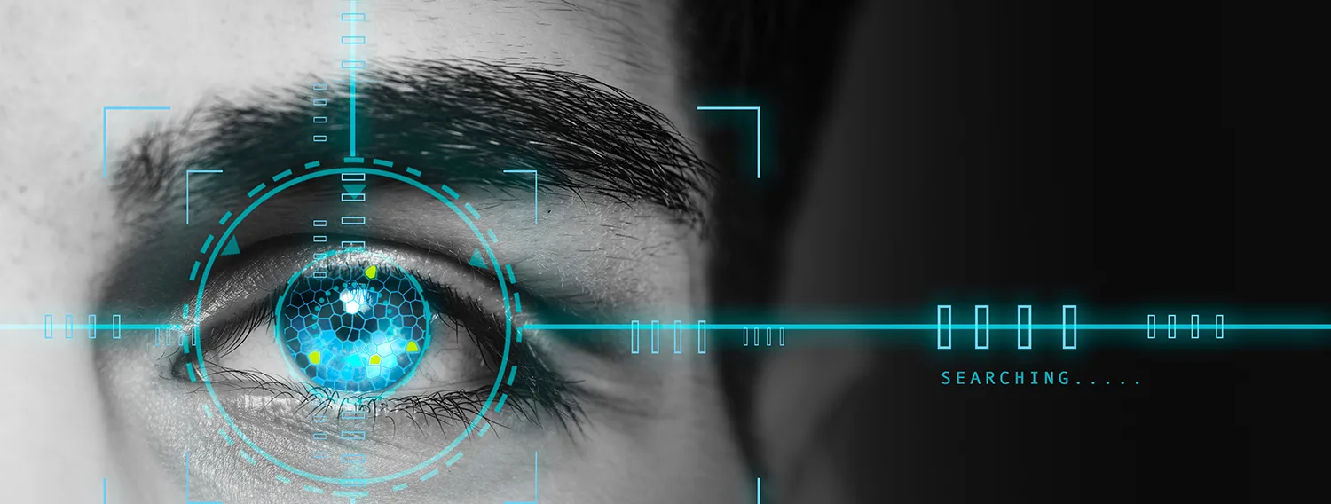 Stylized image of an eye with a glowing, hexagonal iris and targeting reticle, accompanied by the word "SEARCHING..." and digital lines.