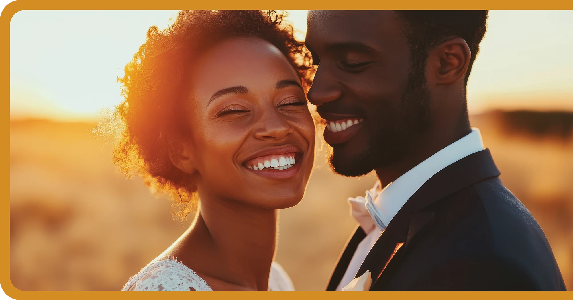 A smiling couple embracing outdoors in a sunlit field, with a warm sunset in the background.