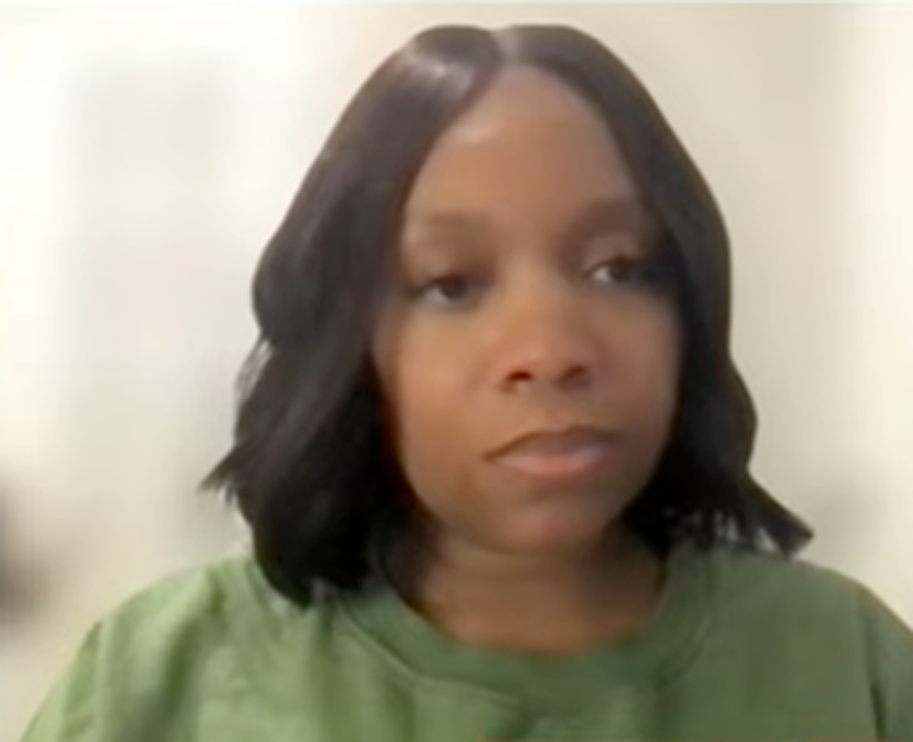 Headshot of a woman with dark hair in a green t-shirt.