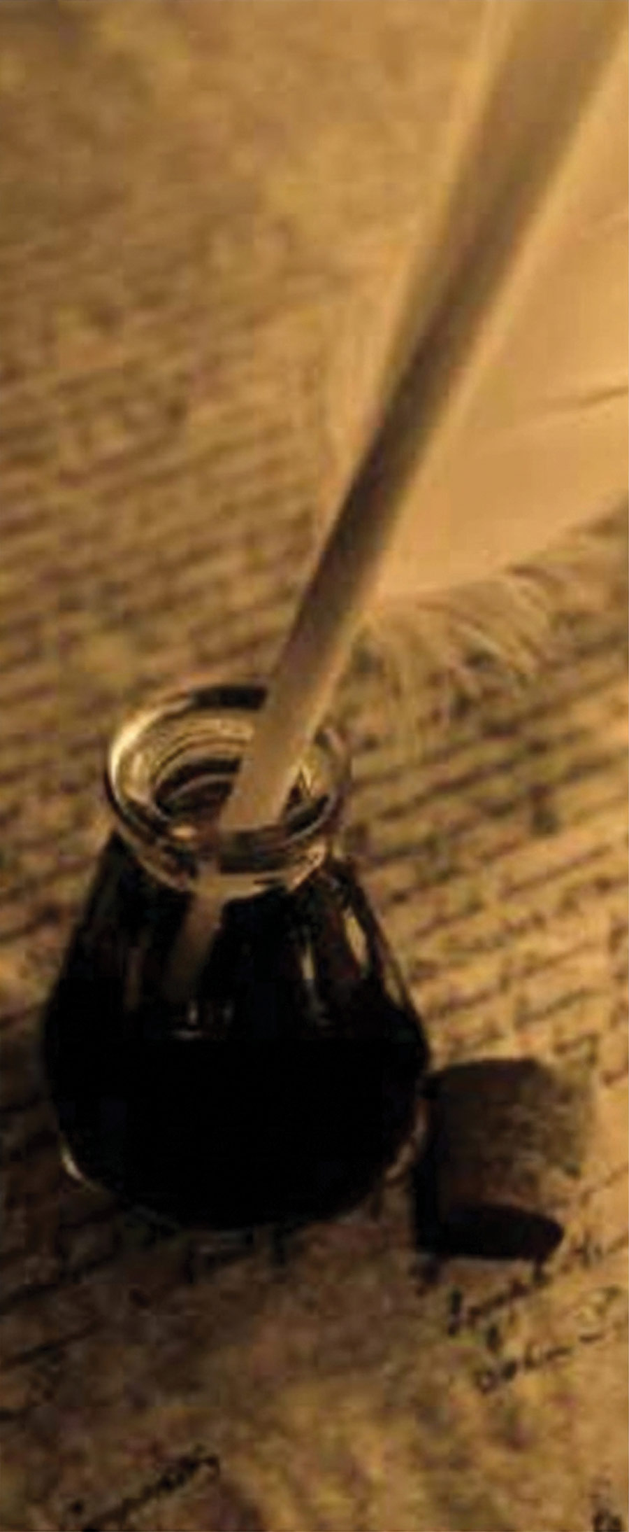 A quill pen sitting inside a glass inkwell resting on handwritten parchment paper.